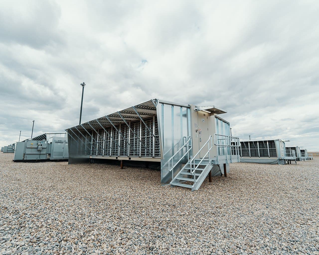 Bitcoin mining farm — rows of specialized ASIC miners in a data center
